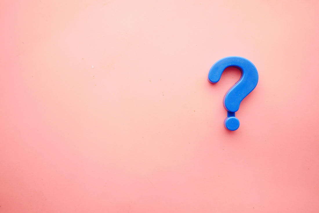 Blue question mark atop a pink background